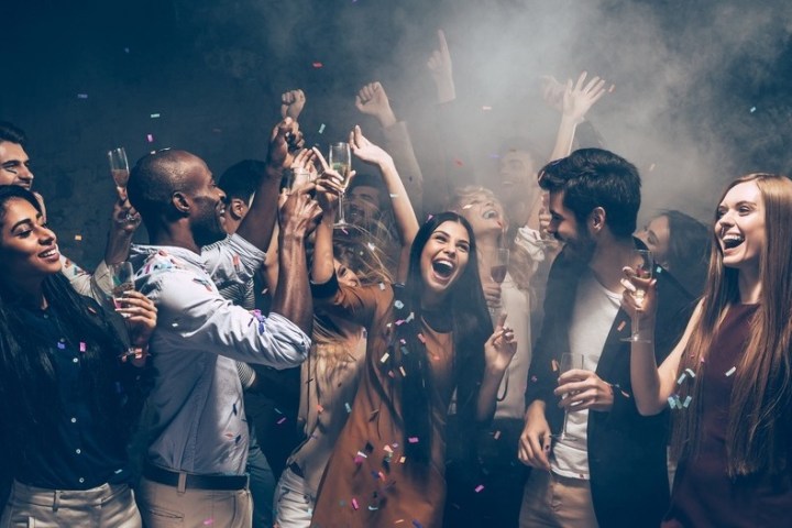 a group of people standing in front of a crowd posing for the camera